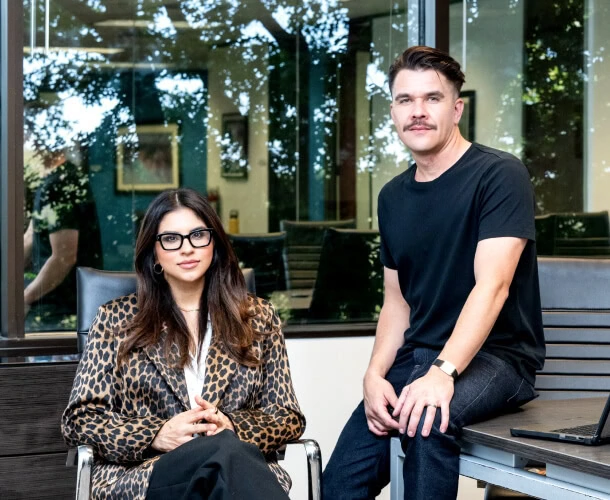 In an Austin office, a person in leopard print exudes VIP flair, while another in black t-shirt stands ready for PR consulting and social media strategy.